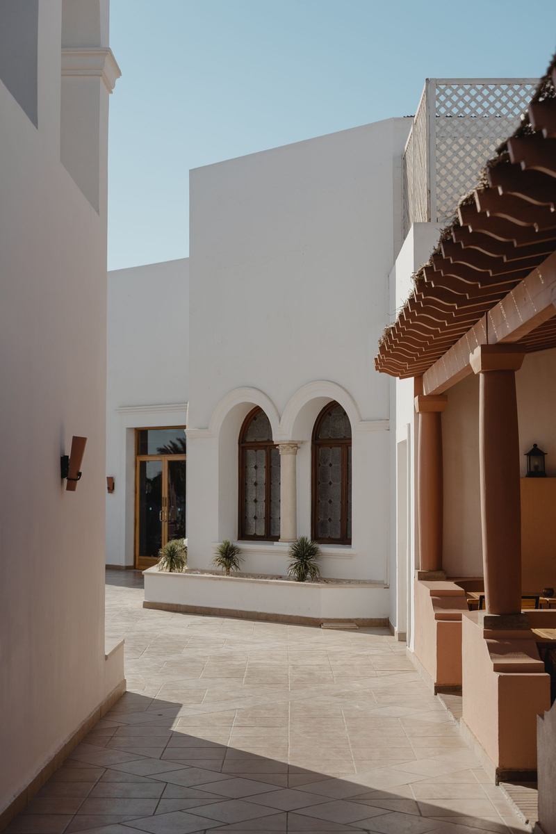 Quiet sunlit courtyard with classical arches